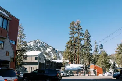 a town with cars parked on a street with a mountain at BEST Location . Walk To Canyon Lodge . Views . Pool/Spa in Mammoth Lakes