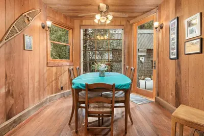 a dining room with a table and chairs at The Knotty Cabin in Kings Canyon National Park in Wilsonia
