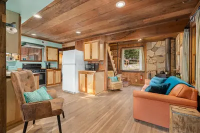 a kitchen and living room in a tiny house at The Knotty Cabin in Kings Canyon National Park in Wilsonia