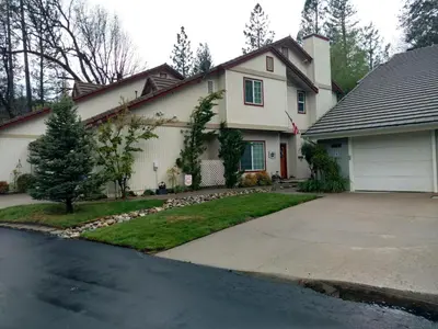 a white house with a driveway in front of it at Forward-Lake Area in Bass Lake