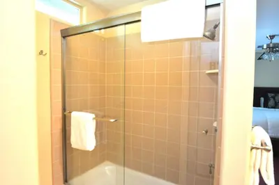 a bathroom with a shower with a glass door at Forward-Lake Area in Bass Lake