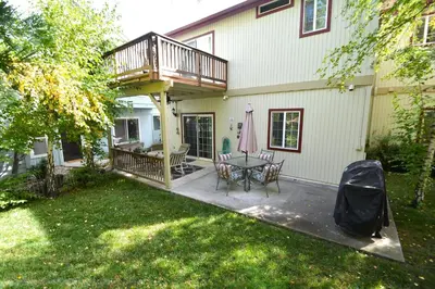 a deck on a house with a table and chairs at Forward-Lake Area in Bass Lake