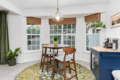 a kitchen with a table and chairs and windows at Lupine Landing in Mariposa