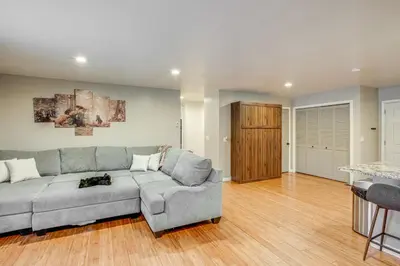 a living room with a gray couch and a wooden floor at Ski and Board in South Lake Tahoe! Updated Home in South Lake Tahoe