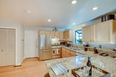a kitchen with wooden cabinets and a stainless steel refrigerator at Ski and Board in South Lake Tahoe! Updated Home in South Lake Tahoe