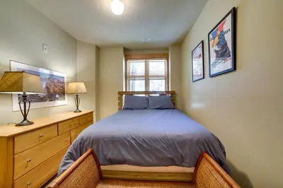 a bedroom with a bed and a wooden dresser at Mammoth Lakes Condo with Fireplace Near Skiing! in Mammoth Lakes