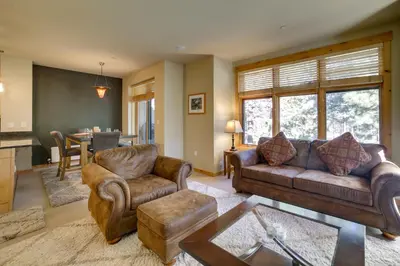 a living room with two couches and a table at Mammoth Lakes Condo with Fireplace Near Skiing! in Mammoth Lakes