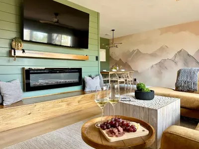 a living room with wine glasses and a mural of mountains at Prime location Yosemite Adventure by Casa Oso in Oakhurst