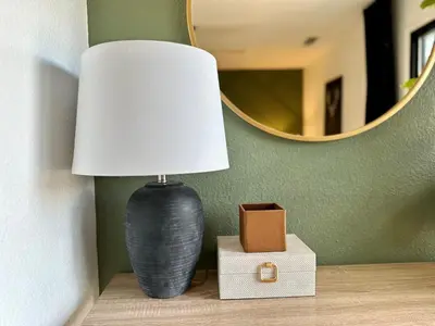 a lamp sitting on a table next to a mirror at Prime location Yosemite Adventure by Casa Oso in Oakhurst