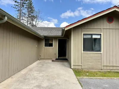 a house with a garage with a driveway at Prime location Yosemite Adventure by Casa Oso in Oakhurst