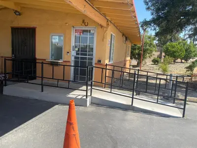 an orange cone in front of a building at Valley Motel in Atwater