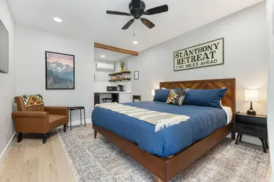 a bedroom with a bed and a chair at The Charlotte Sequoia Motel R2 in Three Rivers