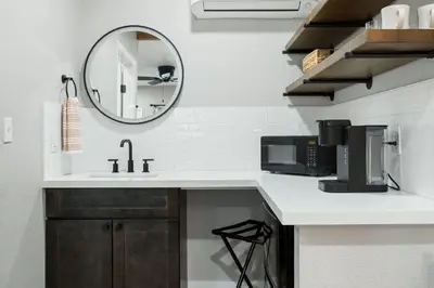 a kitchen counter with a sink and a mirror at The Charlotte Sequoia Motel R2 in Three Rivers