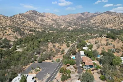 an aerial view of a town with mountains in the background at The Belle Sequoia Motel RM9 in Three Rivers