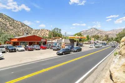a street with cars parked on the side of a road at The Belle Sequoia Motel RM9 in Three Rivers