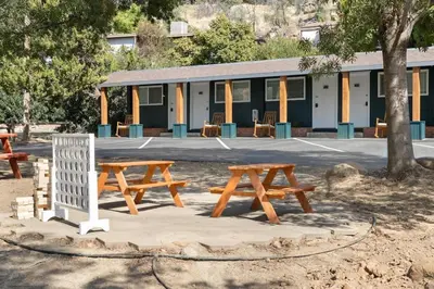a group of picnic tables in front of a building at The Belle Sequoia Motel RM9 in Three Rivers