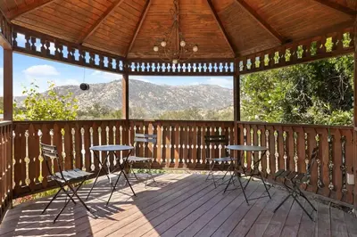 a gazebo with two tables and chairs on a deck at The Belle Sequoia Motel RM9 in Three Rivers