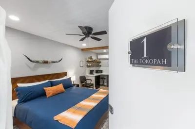 a bedroom with a blue bed and a ceiling fan at The Tokopah Sequoia Motel RM 1 in Three Rivers
