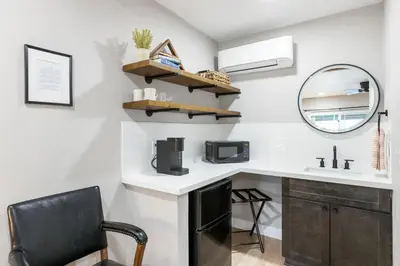a bathroom with a sink and a mirror and a chair at The Tokopah Sequoia Motel RM 1 in Three Rivers