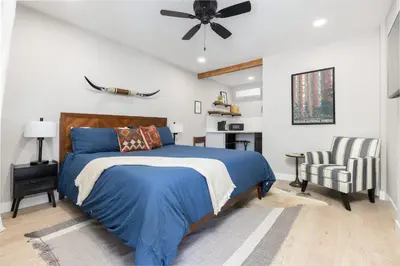 a bedroom with a blue bed and a ceiling fan at The Rae | Sequoia Motel RM 5 in Three Rivers
