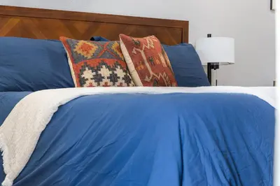 a blue bed with pillows on top of it at The Rae | Sequoia Motel RM 5 in Three Rivers