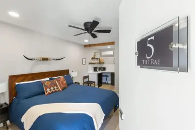 a bedroom with a blue bed and a ceiling fan at The Rae | Sequoia Motel RM 5 in Three Rivers