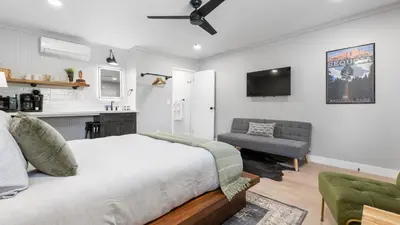 a bedroom with a bed and a couch and a tv at The Whitney- Sequoia Motel RM7 in Three Rivers