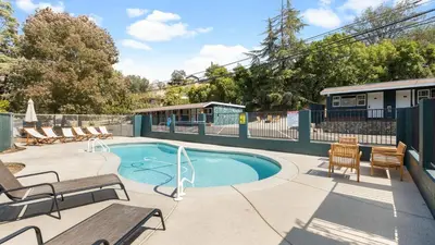 a swimming pool with chairs and a patio with at The Whitney- Sequoia Motel RM7 in Three Rivers