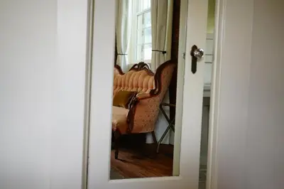 a mirror reflection of a chair in a room at Imperial Hotel + Restaurant in Amador City