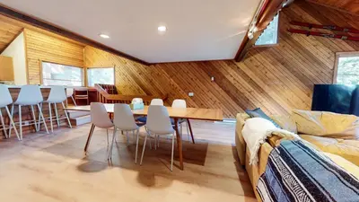 a dining room with a table and white chairs at Snowcreek I #52 condo in Mammoth Lakes