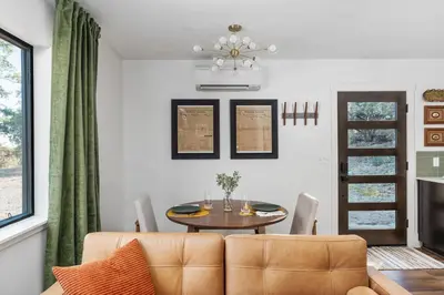 a dining room with a table and a couch at Manzanita Rest in Mariposa