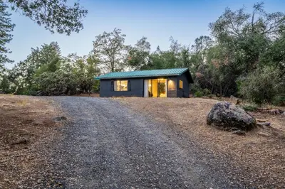 a small house on a hill with a gravel road at Manzanita Rest in Mariposa