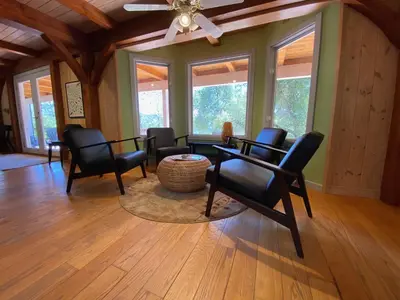 a living room with chairs and a table at Peaceful & secluded, yet close to town. in Mariposa