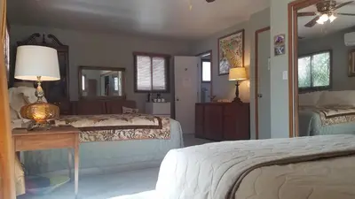a bedroom with two beds and a table with a lamp at Yosemite Plaisance Bed & Breakfast in Mariposa