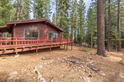 a cabin in the middle of a forest at Cozy Pet-Friendly Cabin w Fenced-In Yard Close to Slopes Beach Town in Carnelian Bay