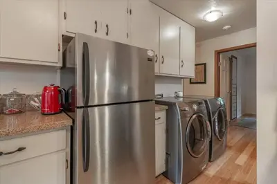 a kitchen with a stainless steel refrigerator and washing machines at Cozy Pet-Friendly Cabin w Fenced-In Yard Close to Slopes Beach Town in Carnelian Bay