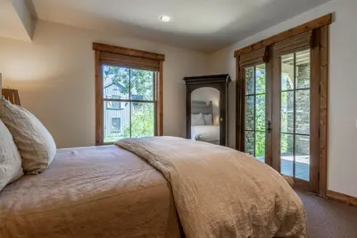 a bedroom with a large bed and a mirror at Lodges 1112 - 3 Bed townhome with Loft in Mammoth Lakes