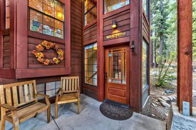 a house with a wooden door and a bench at Donner Lake Inn in Truckee