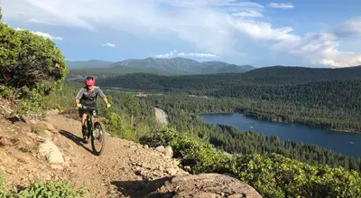 a man riding a bike down a dirt trail at Donner Lake Inn in Truckee