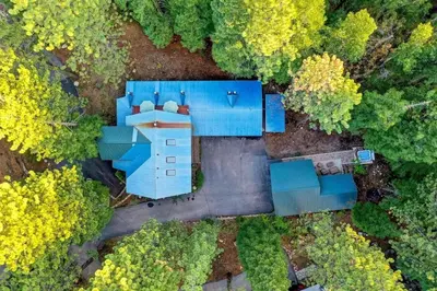 an overhead view of a blue building in the woods at Donner Lake Inn in Truckee