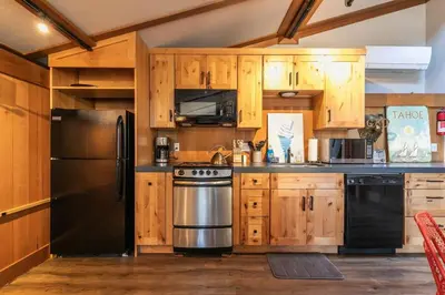 a kitchen with wooden cabinets and a stainless steel refrigerator at Studio with Incredible Location in Tahoe City in Tahoe City
