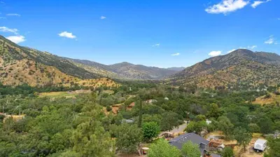 an aerial view of a valley with mountains at SEQUOIA LOOKOUT LODGE in Three Rivers