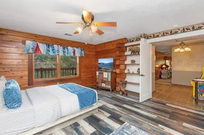 a bedroom with a bed and a ceiling fan at SEQUOIA LOOKOUT LODGE in Three Rivers