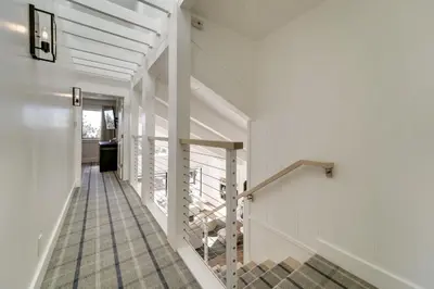 a hallway of a building with white walls and stairs at Steps to Beach Family Home with Views in Tahoe City in Tahoe City