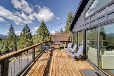a deck with chairs and a grill on a house at Steps to Beach Family Home with Views in Tahoe City in Tahoe City