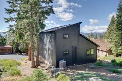 a black house with a tree at Steps to Beach Family Home with Views in Tahoe City in Tahoe City