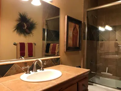 a bathroom with a sink and a shower at Large Family Home in Quiet Wooded Setting Close to Everything in Mevers