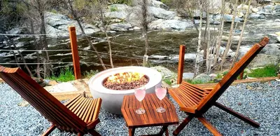 two chairs and a flower pot sitting on a table at Retro House on the River ! in Three Rivers