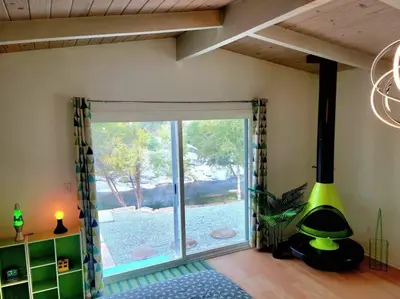 a room with a large sliding glass door with a window at Retro House on the River ! in Three Rivers