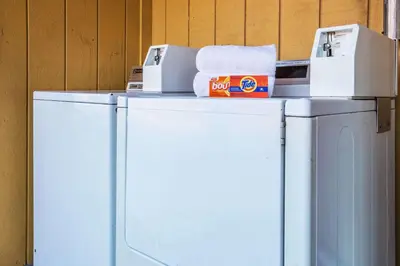 a white refrigerator with boxes on top of it at Travelodge by Wyndham Turlock in Turlock